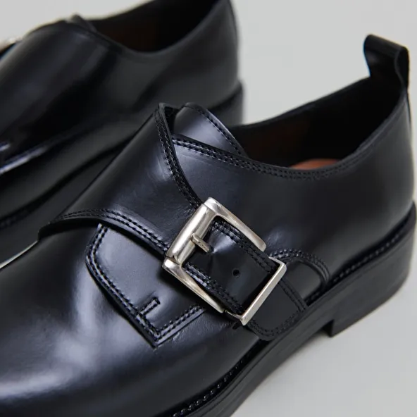 Derbies with adjustable buckles in black glazed leather